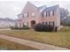 Two story brick home with manicured lawn and shrubs at 1402 Aramore Se Dr, Conyers, GA 30013