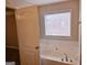 Bathroom with a jetted tub and window with blinds at 1402 Aramore Se Dr, Conyers, GA 30013
