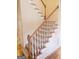 Elegant staircase with wood railing and neutral carpet at 1402 Aramore Se Dr, Conyers, GA 30013