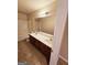 Clean bathroom with double vanity and a tub shower combination at 1402 Aramore Se Dr, Conyers, GA 30013