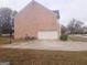 Brick house with a two-car garage and basketball goal at 1402 Aramore Se Dr, Conyers, GA 30013