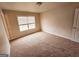 Spacious carpeted bedroom with window and door at 1402 Aramore Se Dr, Conyers, GA 30013