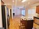 Open concept kitchen with island and hardwood floors at 1402 Aramore Se Dr, Conyers, GA 30013