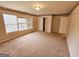 Bright bedroom featuring carpet, a double-door closet, and window with blinds at 1402 Aramore Se Dr, Conyers, GA 30013