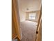 Bright bedroom featuring carpet, large window, and an adjacent door at 1402 Aramore Se Dr, Conyers, GA 30013