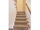 Beige carpeted staircase with wooden railing at 1402 Aramore Se Dr, Conyers, GA 30013