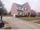 Two story brick home with driveway and a basketball goal at 1402 Aramore Se Dr, Conyers, GA 30013