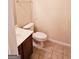 Simple bathroom with single vanity, toilet, and tiled floor at 1402 Aramore Se Dr, Conyers, GA 30013