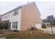 Rear view of the house showcasing a brick exterior and garage at 1402 Aramore Se Dr, Conyers, GA 30013