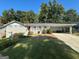 Brick ranch home with covered porch, carport, and well-manicured lawn at 3107 Cherry Blossom Ln, East Point, GA 30344