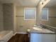 Updated bathroom with granite countertop, bathtub, and modern vanity at 3107 Cherry Blossom Ln, East Point, GA 30344