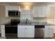 Renovated kitchen, featuring stainless steel appliances and granite countertops at 3107 Cherry Blossom Ln, East Point, GA 30344