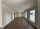 Bright living room featuring hardwood floors, crown molding, and large windows at 3107 Cherry Blossom Ln, East Point, GA 30344