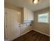Laundry room with built-in cabinets and vinyl flooring at 3107 Cherry Blossom Ln, East Point, GA 30344