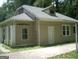 Tan house with a unique roofline and a small driveway at 2945 Palm Dr, East Point, GA 30344