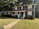 Two-story brick home with a white porch and landscaping at 382 Barbashela Dr, Stone Mountain, GA 30088