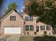 Two-story brick house with a white garage door at 715 Hennepin Ter, Mcdonough, GA 30253