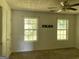 Well lit bedroom with neutral walls and two windows at 715 Hennepin Ter, Mcdonough, GA 30253