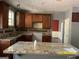 Kitchen with granite countertops and dark wood cabinets at 715 Hennepin Ter, Mcdonough, GA 30253