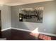 Living room with hardwood floors and a large mirror at 715 Hennepin Ter, Mcdonough, GA 30253