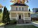 Two-story house with beige siding, a porch, and brick steps at 150 Turman Se Ave, Atlanta, GA 30315