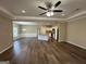 Open floor plan with hardwood floors, kitchen island, and ceiling fan at 150 Turman Se Ave, Atlanta, GA 30315