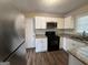 Updated kitchen with white cabinets and granite countertops at 2530 Habersham Dr, Decatur, GA 30032