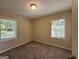Well-lit bedroom featuring neutral wall and carpet colors at 2530 Habersham Dr, Decatur, GA 30032