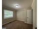 Cozy bedroom with neutral carpeting and large window at 739 Yale Sw Pl, Atlanta, GA 30315