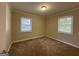 Bright bedroom with neutral carpeting and two windows at 739 Yale Sw Pl, Atlanta, GA 30315