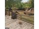 Wooden deck with stonework and railing at 10219 N Dinah Cir, Covington, GA 30014