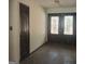 Inviting entryway featuring double doors with stained glass and stone flooring at 10219 N Dinah Cir, Covington, GA 30014