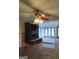 Living room with fireplace, ceiling fan and large windows at 10219 N Dinah Cir, Covington, GA 30014