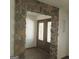 Stone archway entryway with double doors and stained glass at 10219 N Dinah Cir, Covington, GA 30014