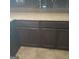 Dark brown kitchen cabinets with granite countertops at 10219 N Dinah Cir, Covington, GA 30014