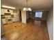 Open concept kitchen with white cabinets and hardwood floors at 493 Village Square Ct, Stone Mountain, GA 30083
