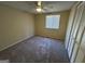 Bright bedroom featuring carpet flooring and window coverings at 493 Village Square Ct, Stone Mountain, GA 30083