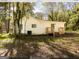 White house exterior with wooden deck and steps, surrounded by trees at 3363 Delmar Nw Ln, Atlanta, GA 30331