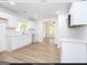 Remodeled kitchen with white cabinets, quartz countertops, and light wood flooring at 3363 Delmar Nw Ln, Atlanta, GA 30331