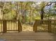 Wooden deck overlooks a wooded backyard with distant homes visible at 3363 Delmar Nw Ln, Atlanta, GA 30331