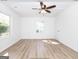 Bright bedroom with ceiling fan, wood-look flooring, and ample natural light at 3363 Delmar Nw Ln, Atlanta, GA 30331