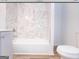 Clean bathroom featuring a white toilet and marble shower/tub combo at 3363 Delmar Nw Ln, Atlanta, GA 30331