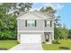 Two-story house with gray siding, white garage door, and a landscaped lawn at 101 Avondale Blvd, Conyers, GA 30013