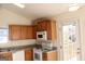 Bright kitchen features wood cabinets, granite countertops, and modern appliances at 6995 Pine Shadow Way, Winston, GA 30187