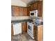 Bright kitchen with wood cabinets, granite counters, and white appliances at 6995 Pine Shadow Way, Winston, GA 30187