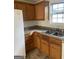This kitchen features wood cabinets, granite countertops, and white appliances at 6995 Pine Shadow Way, Winston, GA 30187