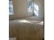 Bright bedroom featuring carpeted floors and large windows at 6995 Pine Shadow Way, Winston, GA 30187