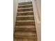 Beige carpeted stairs leading to the second floor at 6995 Pine Shadow Way, Winston, GA 30187