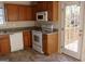 Kitchen with wooden cabinets, white appliances, and access to a deck at 6995 Pine Shadow Way, Winston, GA 30187