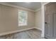 Bright bedroom with a window, neutral walls and wood-look flooring at 5122 Hillcrest Nw Dr, Covington, GA 30014